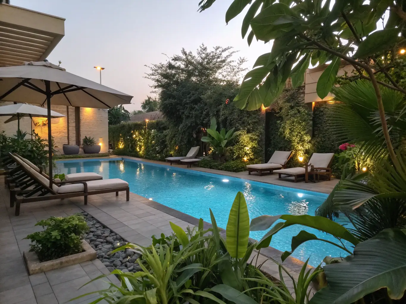 A beautifully designed backyard with a modern, freeform swimming pool surrounded by lush landscaping and outdoor furniture, showcasing 4N Outdoor Living & Pools' custom pool design and construction service.